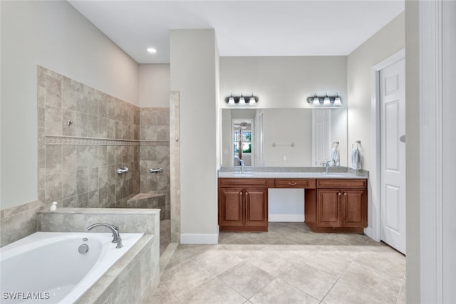 bathroom featuring shower with separate bathtub, vanity, and tile patterned floors