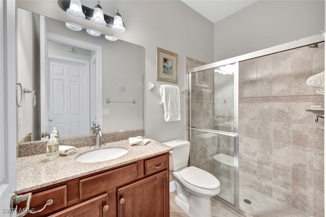 bathroom featuring vanity, toilet, and walk in shower