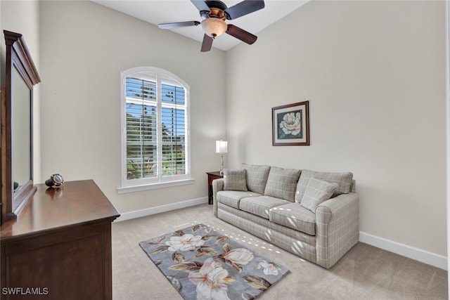 living room featuring ceiling fan and light colored carpet