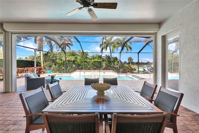 sunroom featuring ceiling fan