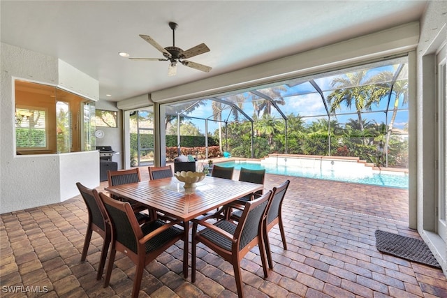 sunroom featuring ceiling fan