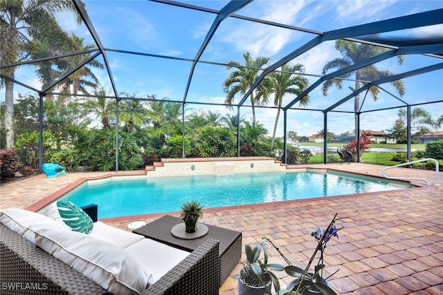 view of swimming pool with a patio area, pool water feature, and glass enclosure