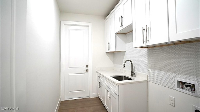 laundry room featuring cabinets, hookup for a washing machine, dark wood-type flooring, and sink