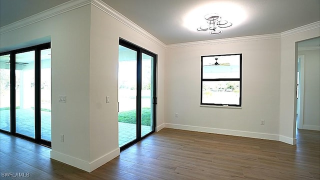 spare room with ceiling fan, dark wood-type flooring, and ornamental molding