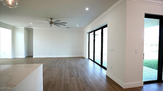 interior space with dark hardwood / wood-style floors, ceiling fan, and ornamental molding