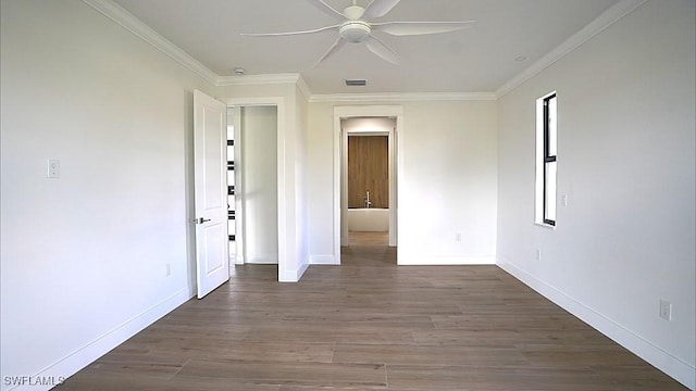 empty room with ceiling fan, crown molding, and dark wood-type flooring