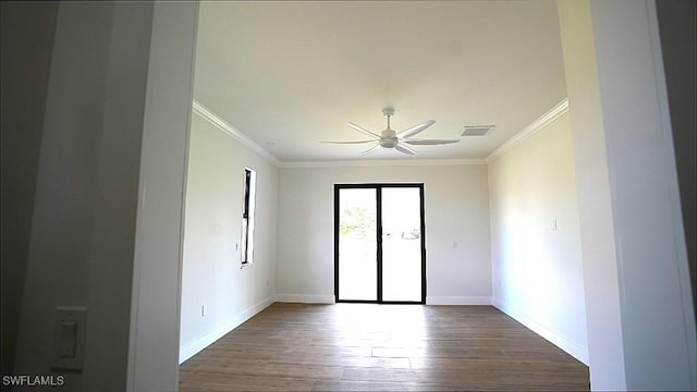 spare room featuring ceiling fan, dark hardwood / wood-style floors, and ornamental molding