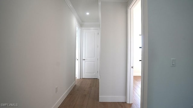 corridor with crown molding and hardwood / wood-style floors