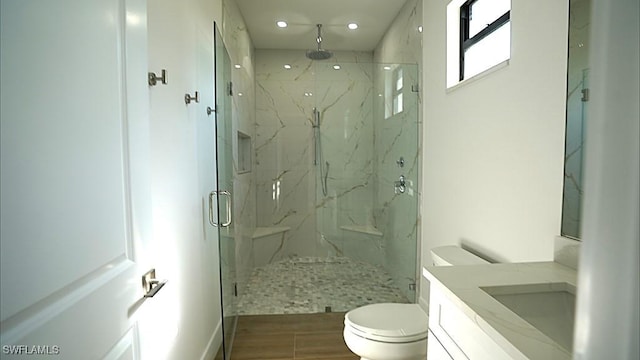 bathroom with vanity, toilet, and walk in shower