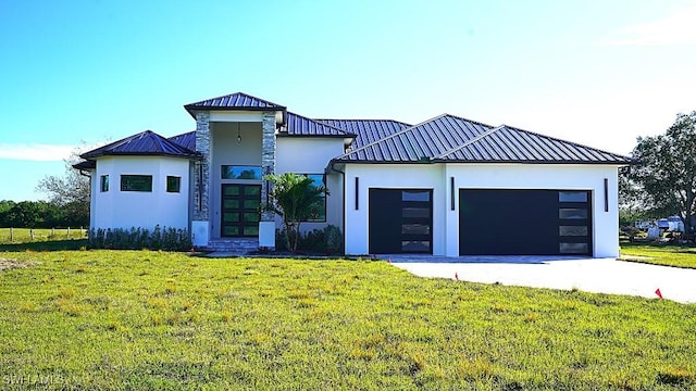 view of front of home with a front lawn and a garage