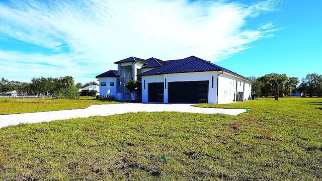 view of front of home with a front yard and a garage