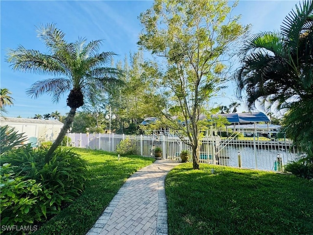 view of yard featuring a boat dock and a water view