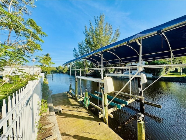 view of dock featuring a water view and boat lift