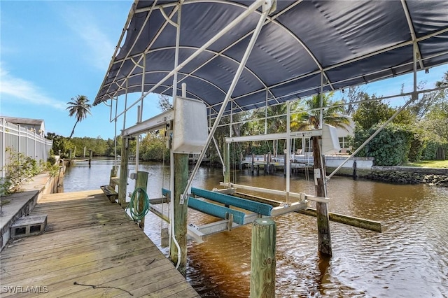 dock area featuring a water view and boat lift