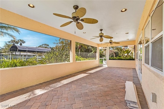 view of patio with ceiling fan and fence