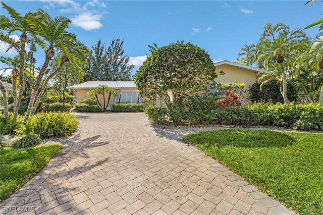 view of front of home featuring decorative driveway and stucco siding