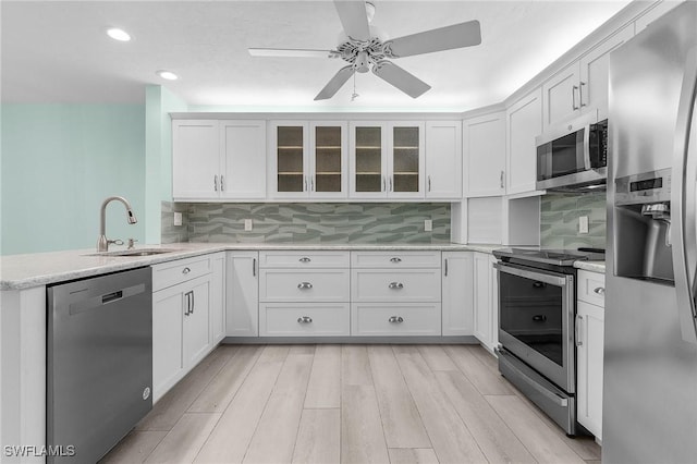 kitchen with white cabinetry, appliances with stainless steel finishes, and a sink