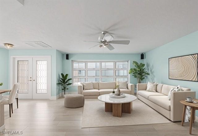 living room with french doors, visible vents, light wood-style flooring, a ceiling fan, and baseboards