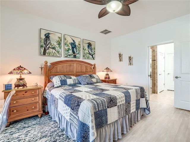 bedroom featuring ceiling fan, light wood-type flooring, and ensuite bathroom