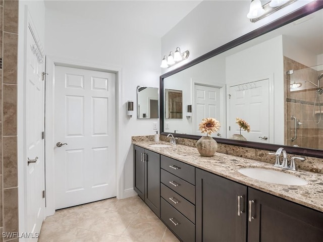 bathroom featuring tile patterned floors, vanity, and walk in shower