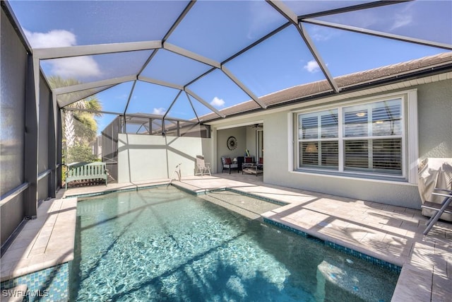 view of swimming pool featuring glass enclosure and a patio