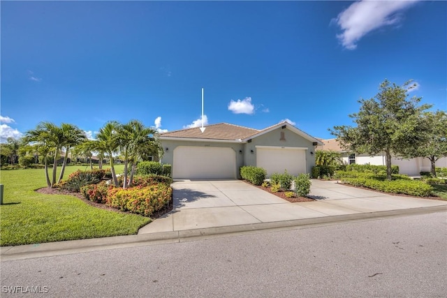 view of front of property with a front lawn and a garage