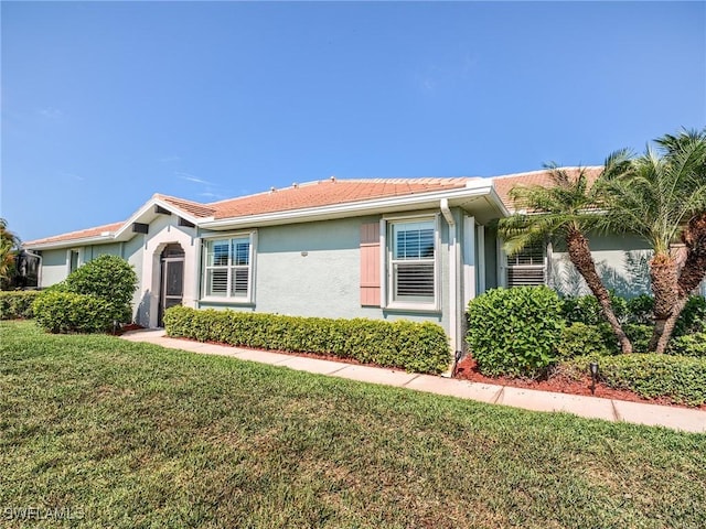 ranch-style home with a front lawn