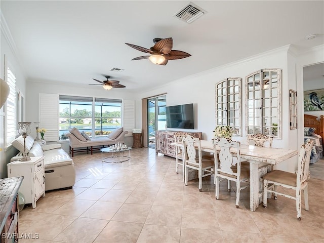 dining area featuring a wealth of natural light, ceiling fan, crown molding, and light tile patterned flooring