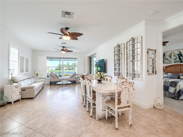 tiled dining room featuring ceiling fan and ornamental molding