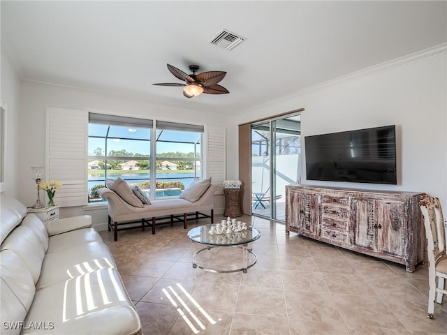 tiled living room with ceiling fan and ornamental molding