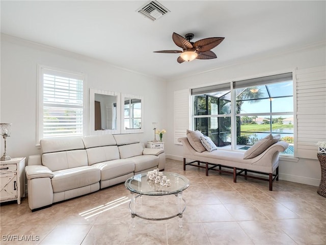 living room with ceiling fan, light tile patterned floors, and ornamental molding