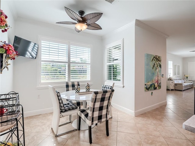 tiled dining room featuring ceiling fan and crown molding