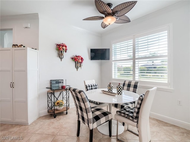 tiled dining area with crown molding and ceiling fan