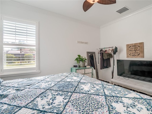 bedroom with ceiling fan and crown molding