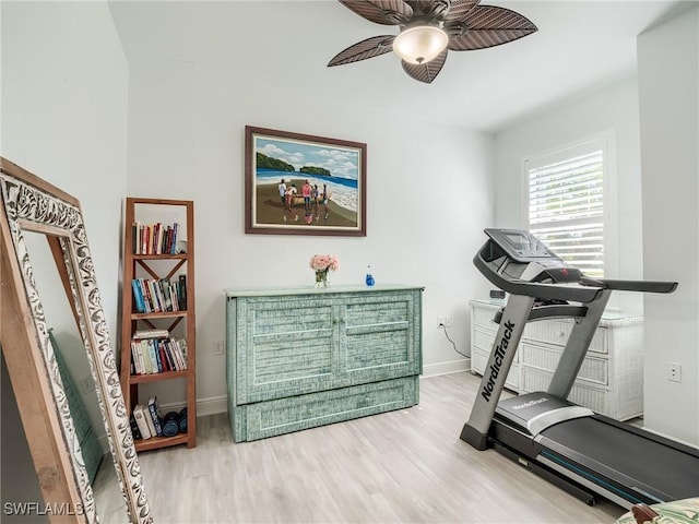 exercise room with ceiling fan and wood-type flooring