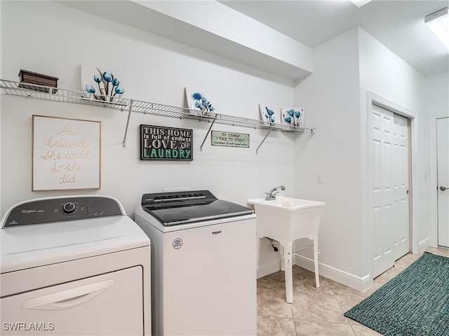 clothes washing area with light tile patterned floors and washing machine and clothes dryer