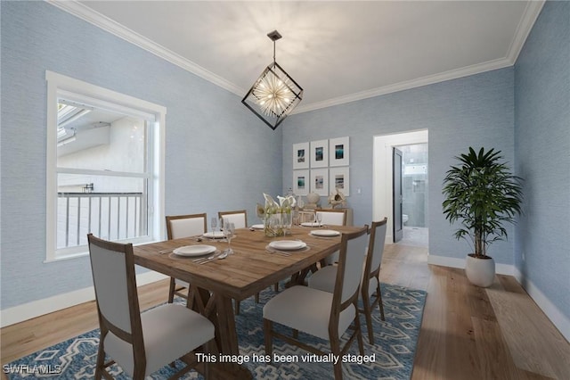 dining space with ornamental molding and hardwood / wood-style flooring