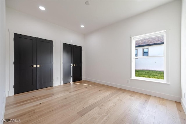 unfurnished bedroom with light hardwood / wood-style flooring