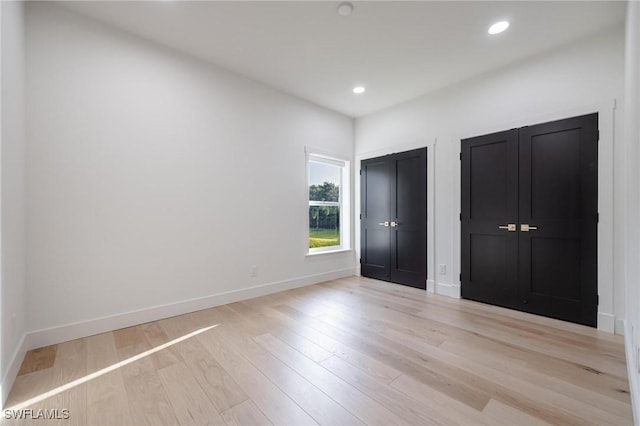 unfurnished bedroom featuring light wood-type flooring