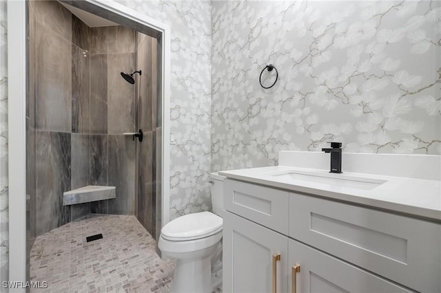 bathroom with tile patterned flooring, toilet, a shower, and vanity