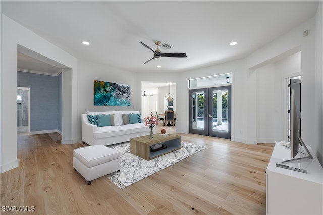 living room featuring french doors, light hardwood / wood-style flooring, and ceiling fan