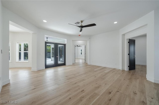 unfurnished living room featuring ceiling fan, light hardwood / wood-style flooring, and french doors