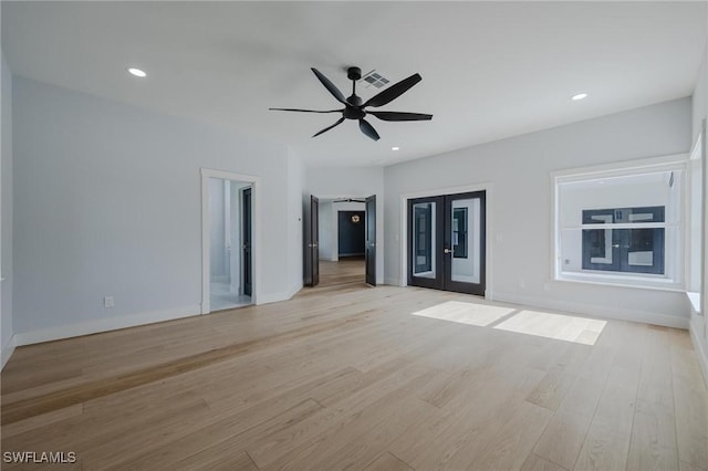 spare room with french doors, light hardwood / wood-style floors, and ceiling fan