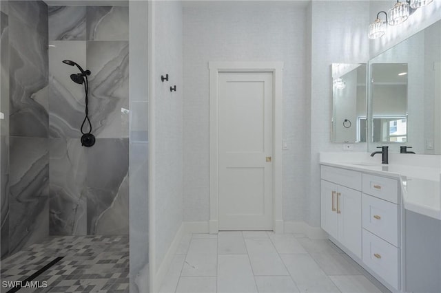 bathroom with vanity and tiled shower