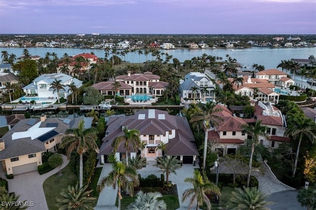 aerial view at dusk with a water view