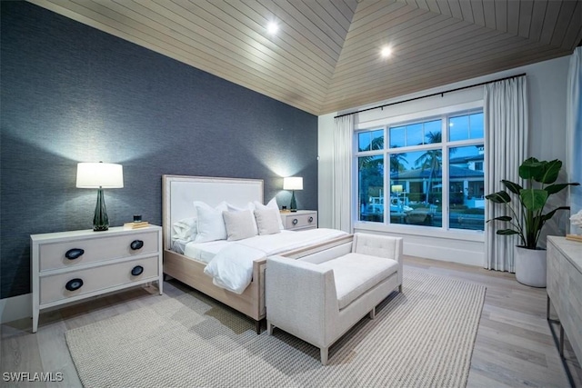 bedroom featuring light hardwood / wood-style flooring, wood ceiling, and lofted ceiling