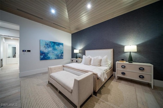 bedroom featuring wooden ceiling, light hardwood / wood-style floors, and lofted ceiling