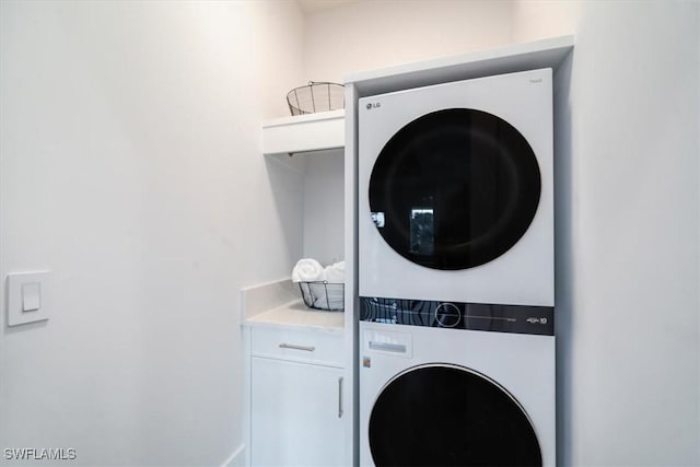 washroom with stacked washer / drying machine