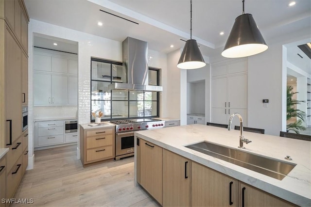 kitchen featuring sink, light brown cabinets, pendant lighting, extractor fan, and stainless steel stove