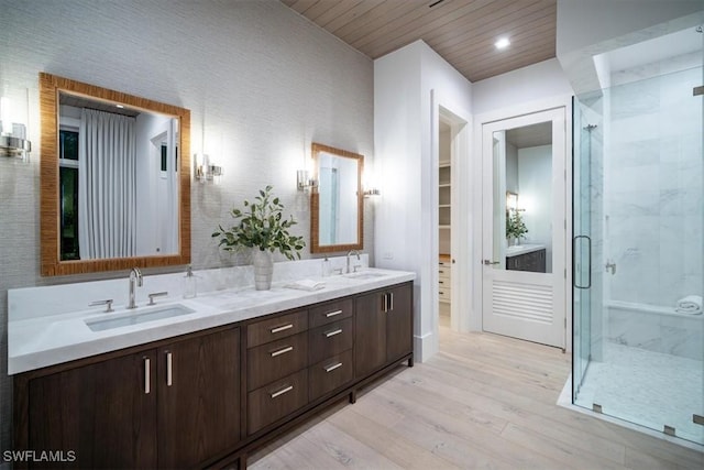 bathroom with hardwood / wood-style floors, vanity, a shower with shower door, and wood ceiling